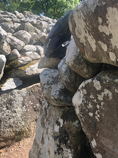 Backpack in stone wall where a stone ought to be