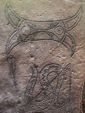 Carving of monster with snake