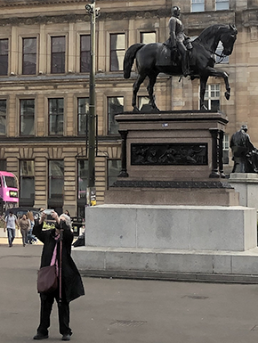 Susan taking photo with statue of Prince Albert in background