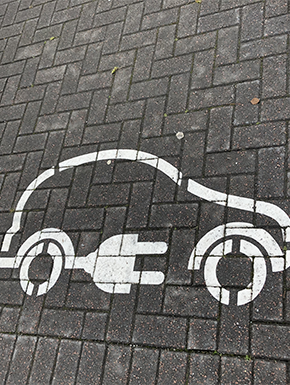 Electric car symbol painted on pavement