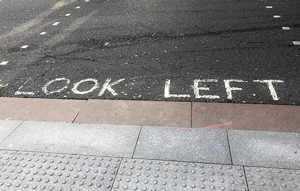 LOOK LEFT painted on pavement