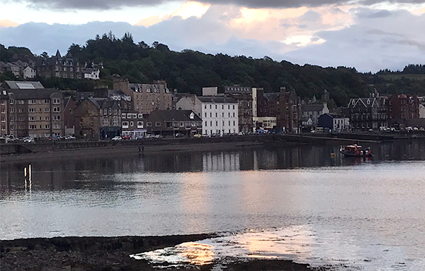 Village in front of hills at sunset with pretty reflection in water 