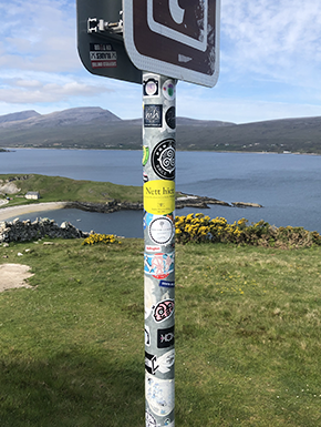 Sign with stickers on sign post