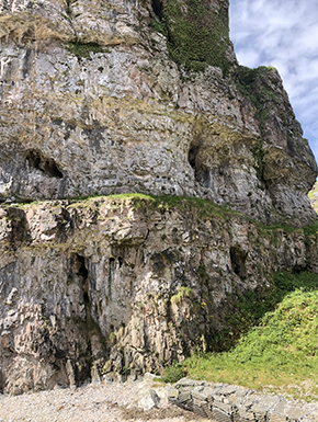 Rocky cliff with small caves