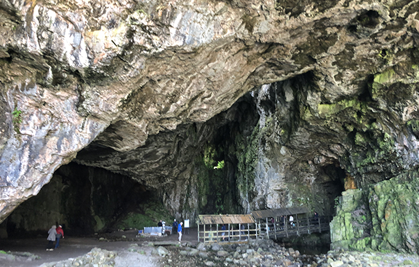 Large cave with tiny people