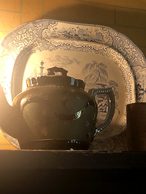 Brown teapot on shelf with platter