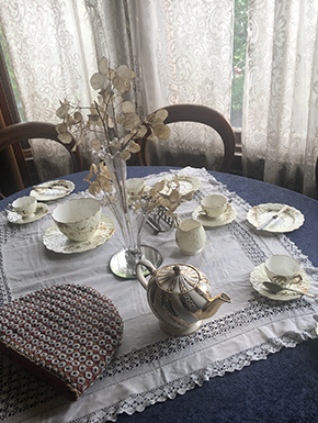 Antiques tea party setting with lace curtains