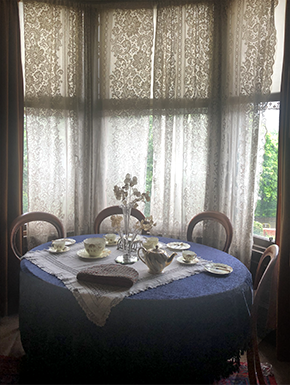 Antiques tea party setting with lace curtains