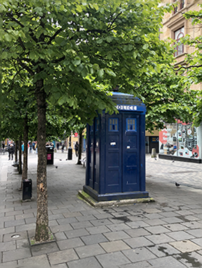 Blue police box on pedestrian mall, closer