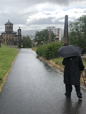 Necropolis with Susan holding umbrella in rain