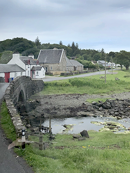 Village scene with road entering over bridge