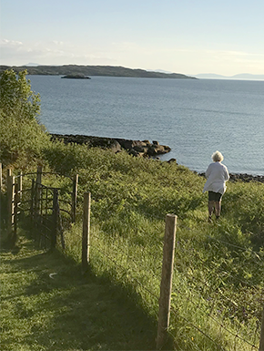 Me on hill looking out at water: kissing gate