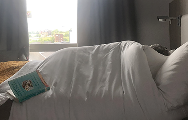 Susan sleeping with book in her bed.