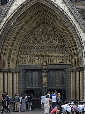 Ornate door to Parliment with lines waiting to enter