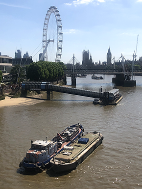 RIver Thames with garbage barges: ferris wheel and other landmarks