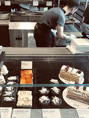 Pastry display, with worker