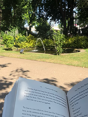 Open book in foreground, fountain 