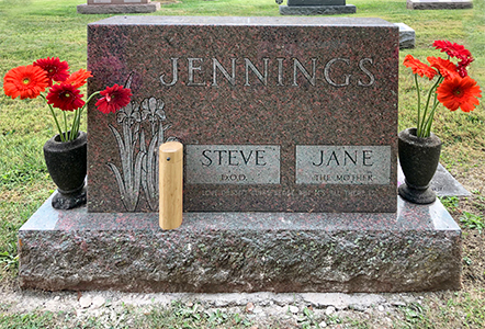 TAombstone with flowers, ashes, an urn.