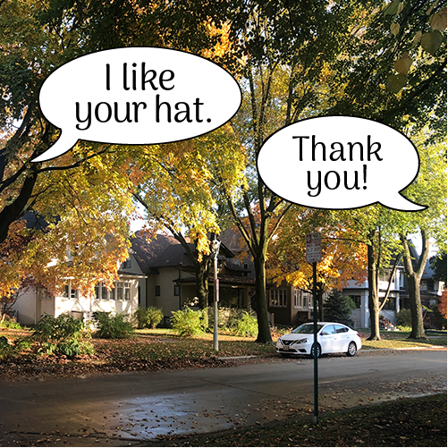 "I like your hat." "Thank you!" in simple street scene