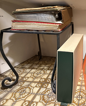 photos tucked behind chair in fireplace