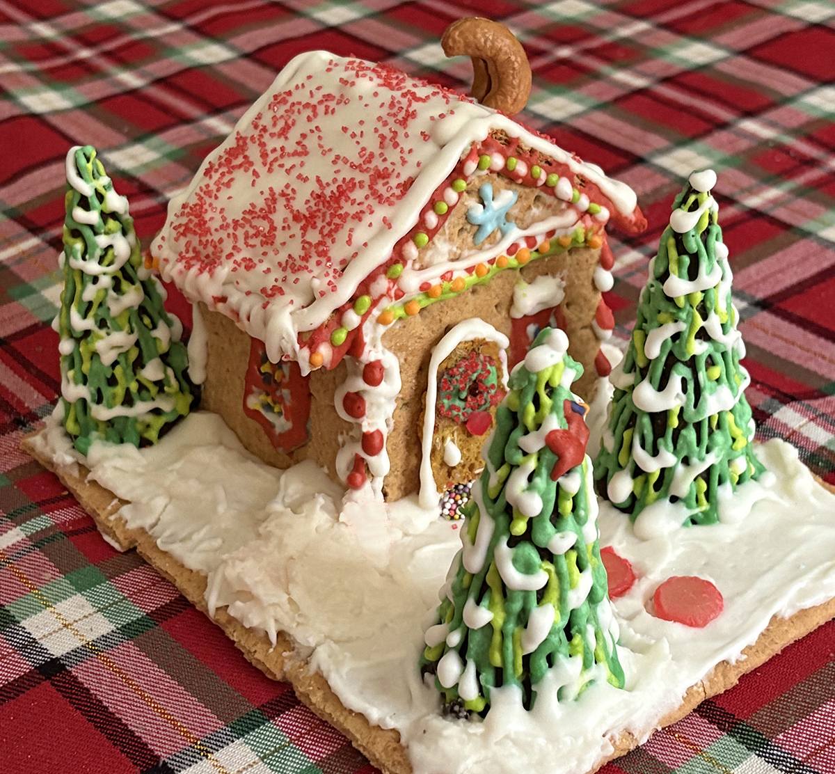 Christmas cabin made of iced graham crackers